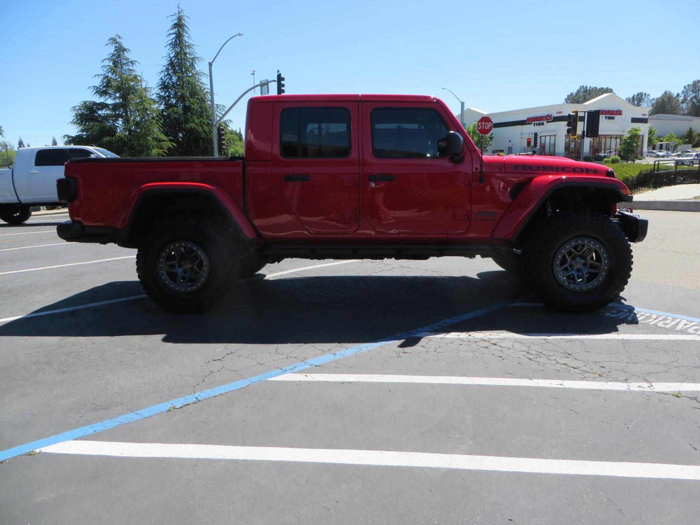 2020 Red /black Jeep Gladiator Rubicon (1C6JJTBG6LL) with an 3.6L V6 DOHC 24V engine, 6M transmission, located at 2630 Grass Valley Highway, Auburn, CA, 95603, (530) 508-5100, 38.937893, -121.095482 - Rubicon Gladiator featuring a Mopar suspension system with Fox shocks, 17" AEV wheels wrapped in 37" BFG tires, Warn Winch, Rock sliders, Cascade front license plate holder, Impact bedliner, Built Right Industries bed Molle panels, and Window tint. - Photo#3